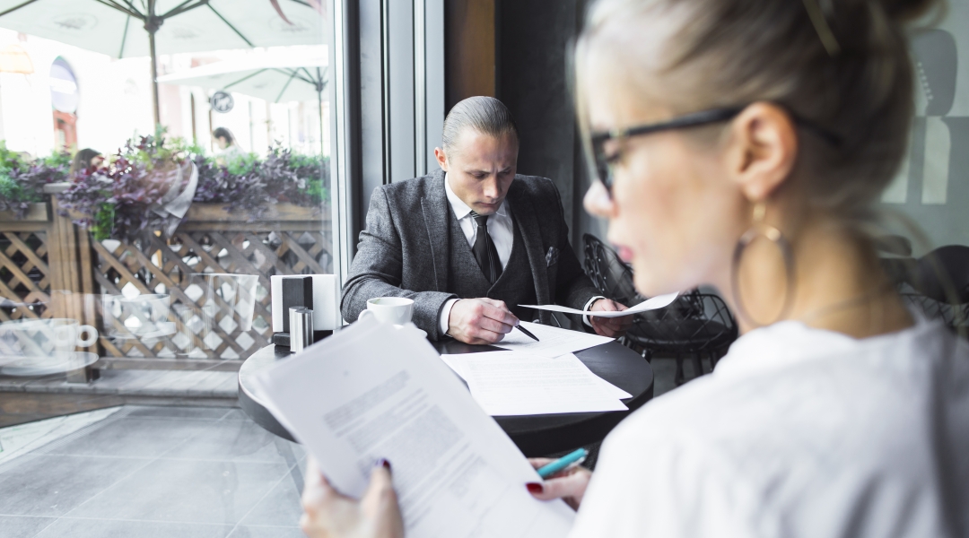 beautiful-young-woman-checking-documents-caf.jpg